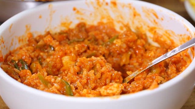 Spoonful of spicy pork stew mixed with rice