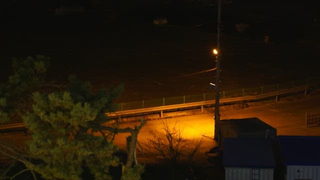 Nighttime street scene with street lamp casting light