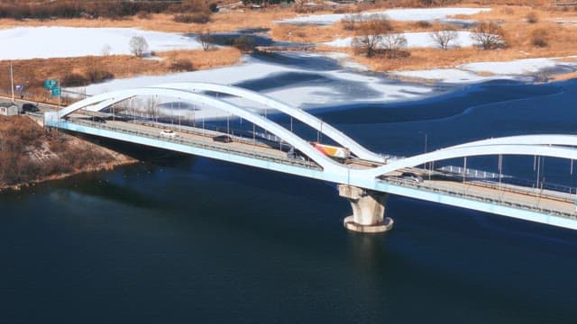 Snowy Riverside Bridge With Traffic