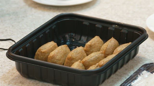 Fried Bean Curd Rice Ball in a Plastic Disposable Container
