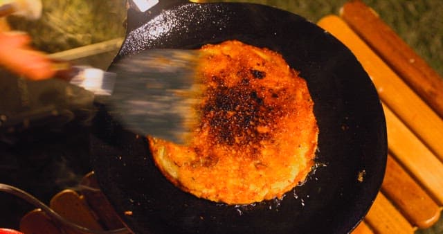 Preparing Savory Korean pancake on a Hot Skillet
