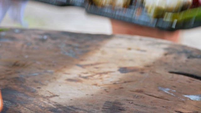 Barbecue grill with grilled parrotfish, onions and peppers served on the table