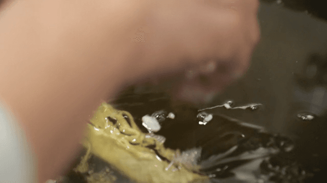 Hand frying spring roll dough in hot oil