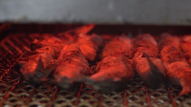 Grilled fish sizzling on a hot grill