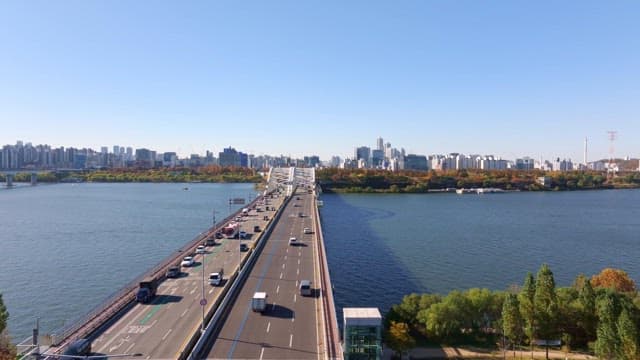 Bridge over a river with city skyline