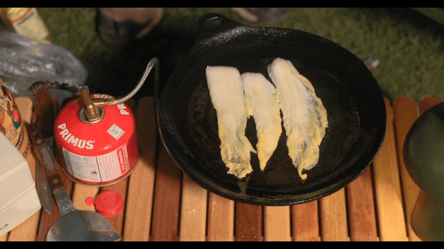 Preparing a meal outdoors with a portable stove