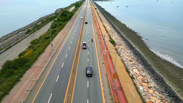 Coastal highway with cars and ocean view