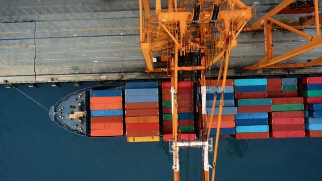 Cargo Ship with Containers and Cranes at Port