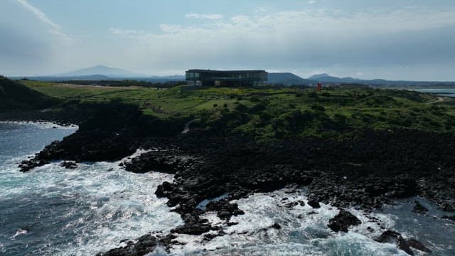 Coastal Landscape with Lush Greenery and Modern Building