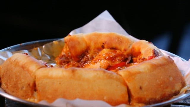 Slice of Chicago pizza with stretchy cheese