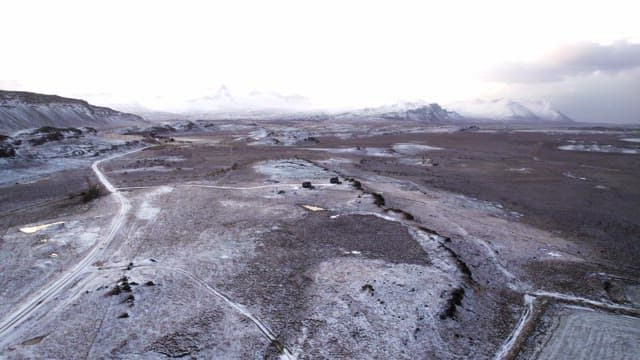 Snow-covered landscape with distant mountains