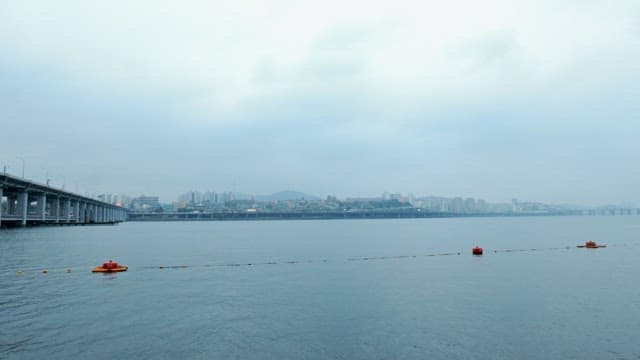 Overcast Sky Over Urban Waterway and Bridge