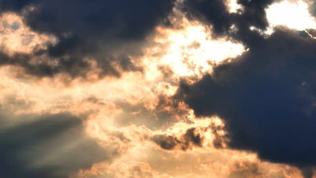 Sunlight breaking through dark clouds