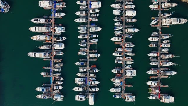 Numerous yachts anchored in the harbor on a clear day