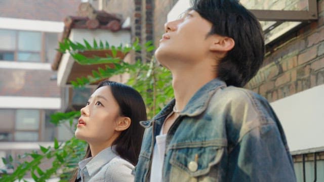 Couple sitting in an alley and looking up