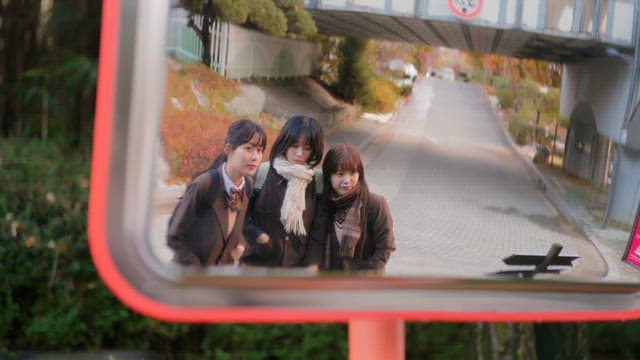 Three friends taking selfies in a mirror