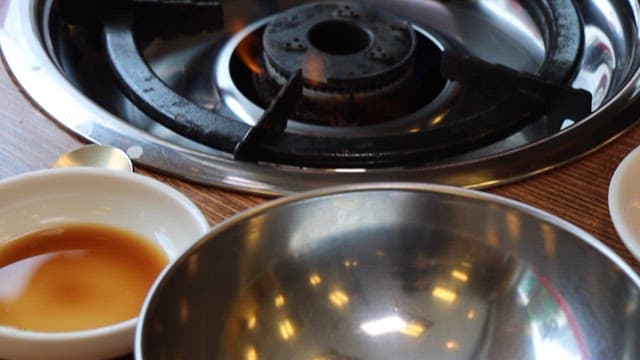 Appetizing spicy fish stew served on a gas stove on a restaurant table