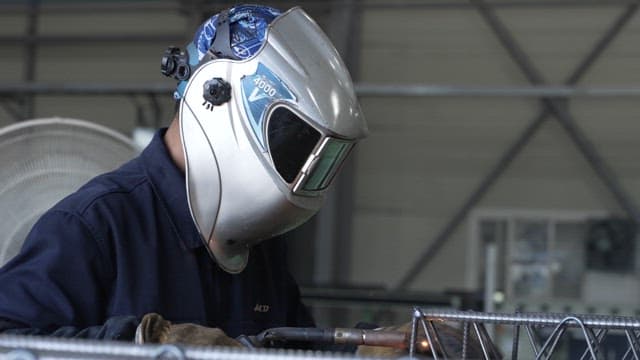 Workers welding in a factory