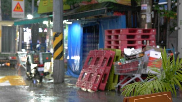 Alley with a supermarket in sight on a rainy day