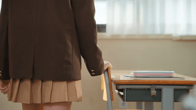 Student standing by the classroom window