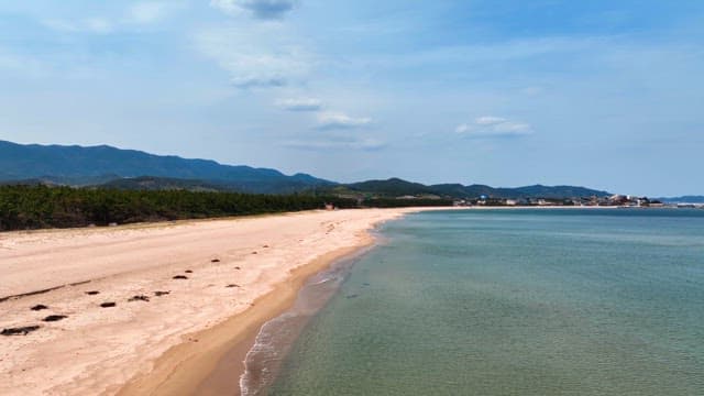 Serene beach with distant mountains
