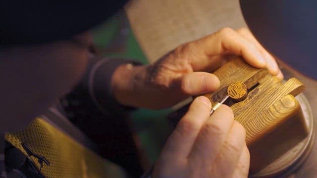 Craftsman Carving Wood in Workshop
