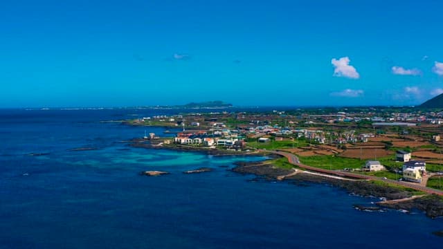 Aerial View of Coastal Town and Blue Ocean