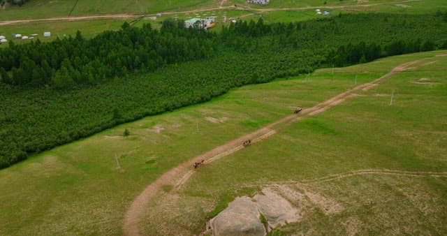 Green hills and mountains with distant village