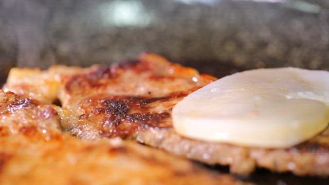 Scallop slices on top of sizzling beef