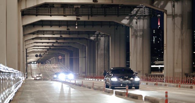 Nighttime Drive in an Illuminated Bridge