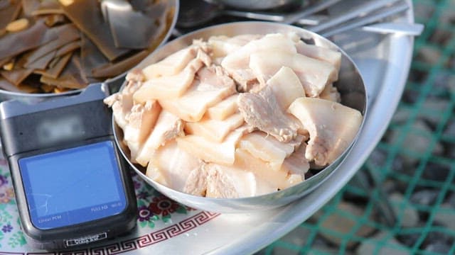 Table of boiled pork, kelp, abalone, and kimchi