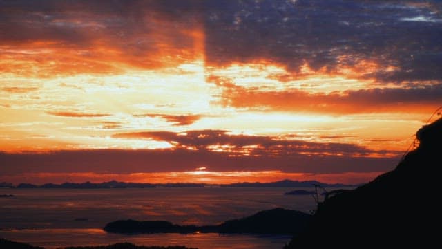Vibrant sunset over the mountains and ocean