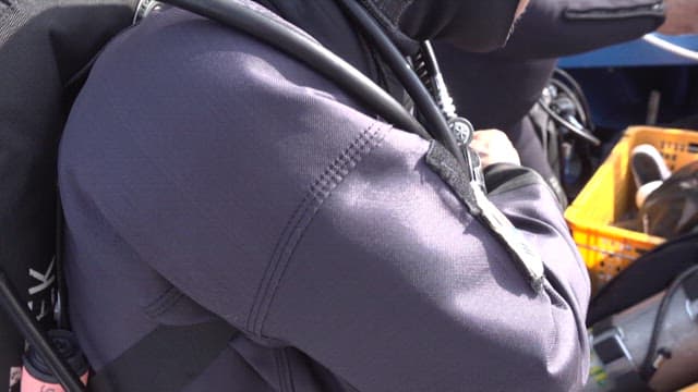 Scuba divers preparing for a dive on a boat
