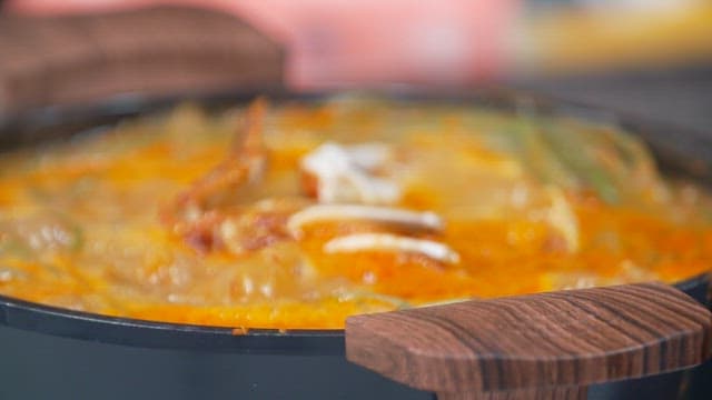 Deliciously boiling crab soup with sweet potato stem in a pot