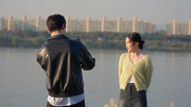 Woman posing for a photo by the river