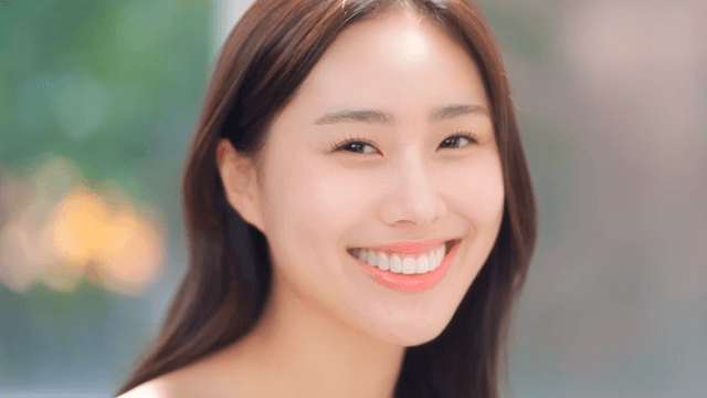 Woman looking straight ahead with a confident smile