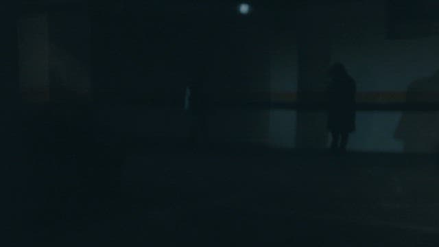 Silhouettes of People Meeting in a Dark Parking Lot