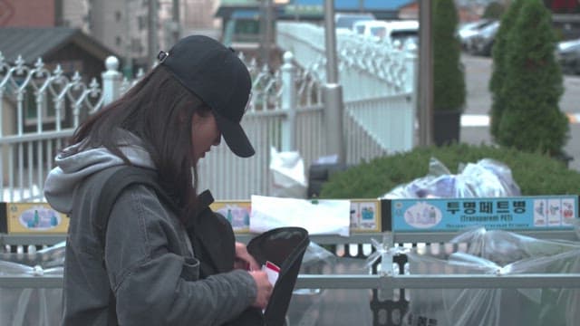 Woman separating trash from bag