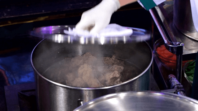 Pork backbones cooking in a sot