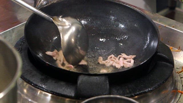 Stir-frying meat in a hot pan