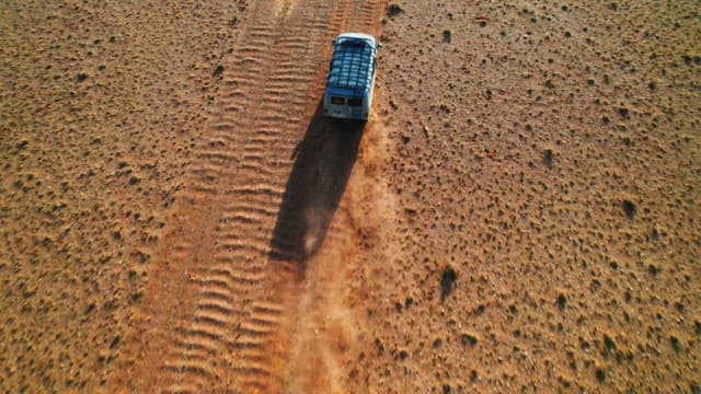 Truck traversing a dusty desert road