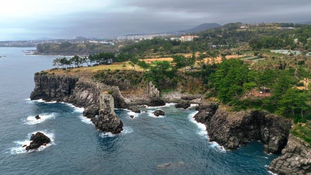 Coastal cliffs and distant cityscape