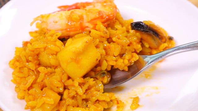 Spoonful of seafood paella on a plate