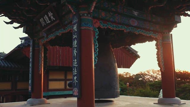 Traditional Temple Bell with Sunset