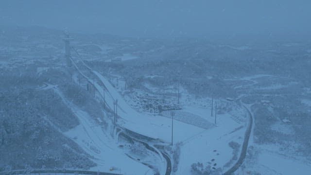 Snow-covered Ski Jumping Hill at Dusk