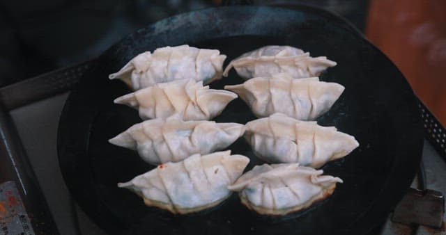 Dumplings Sizzling on a Hot Pan