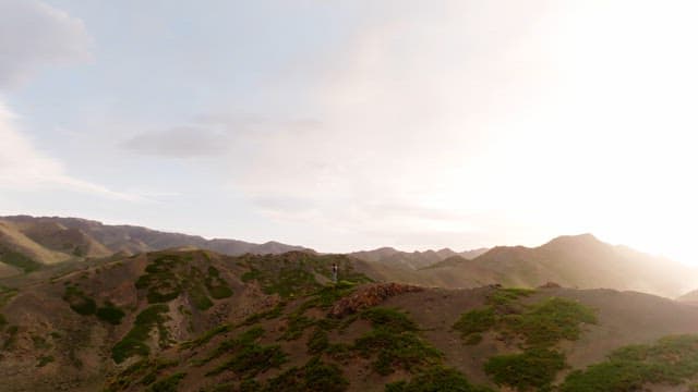 Person standing on a mountain in the sunlight