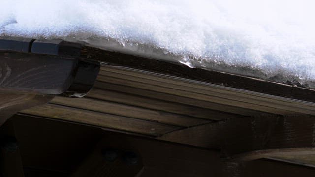 Snow-covered roof of a wooden structure