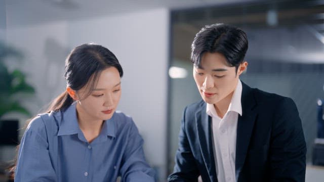 Two colleagues discussing documents