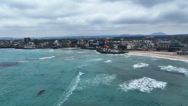 Coastal city with kite surfers on the sea